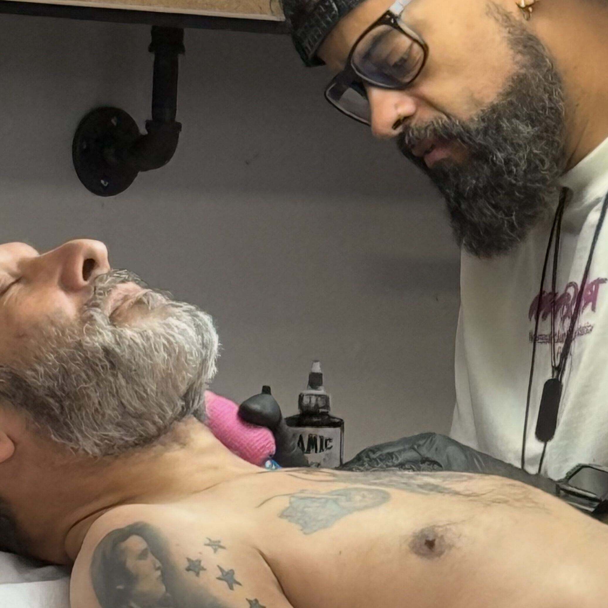 Talented black and grey tattoo artist Andres Flu tattooing a neck in Midtown Manhattan.